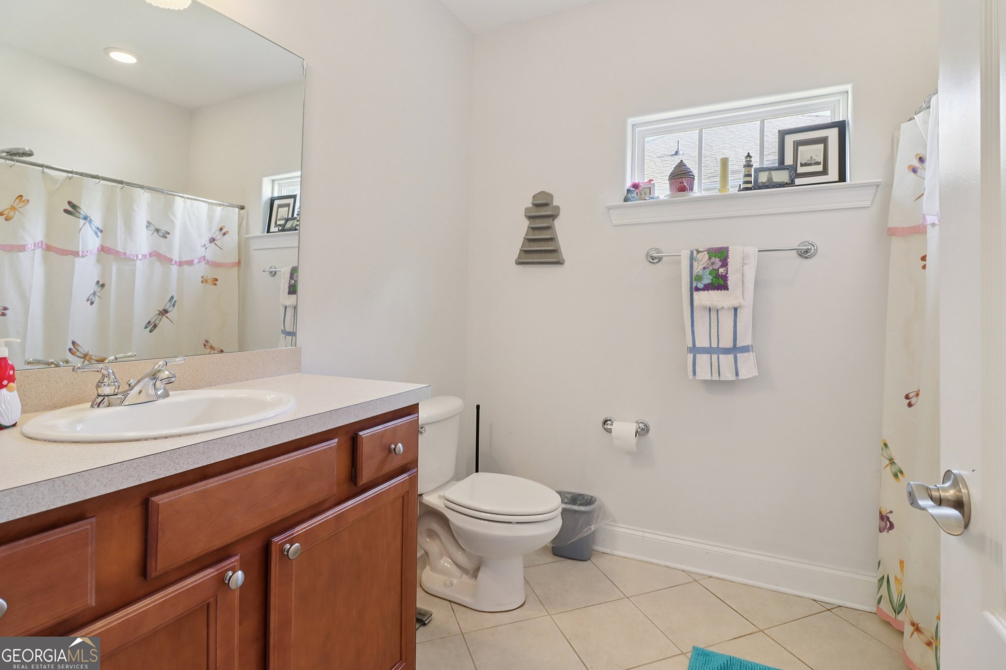 1502 Commonwealth Circle Newnan, GA 30263 - Photo 20 of 30 a bathroom with a granite countertop sink toilet and a mirror