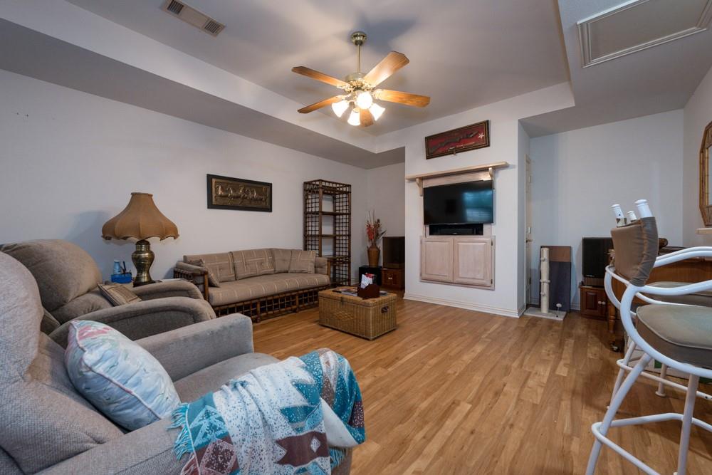 9554 David Fort Road Argyle, TX 76226 - Photo 7 of 35 a living room with furniture a flat screen tv and a chandelier