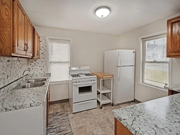 a kitchen with a stove a sink and a refrigerator