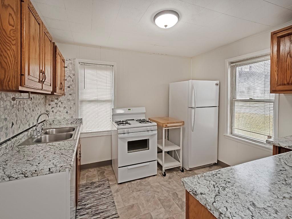 424 2nd Avenue Cadogan, PA 16212 - Photo 11 of 25 a kitchen with a stove a sink and a refrigerator