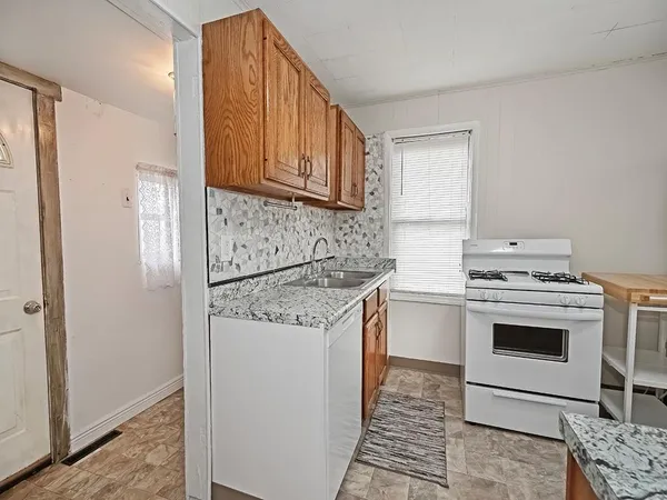 a kitchen with a stove sink and refrigerator