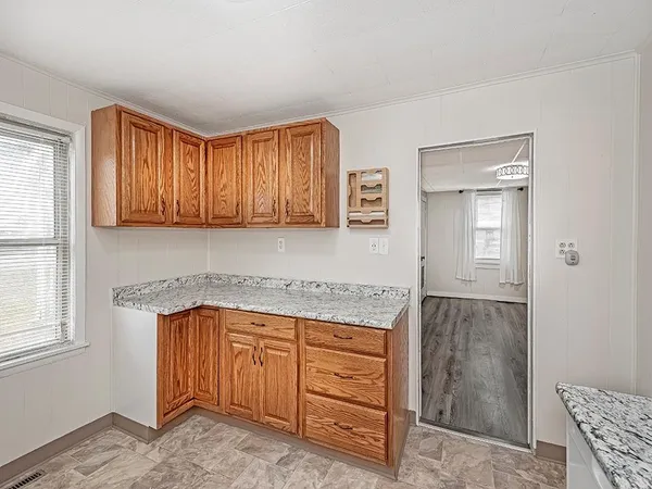 a kitchen with granite countertop cabinets and window