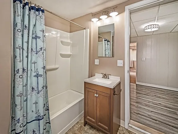 a bathroom with a granite countertop sink a shower and a mirror
