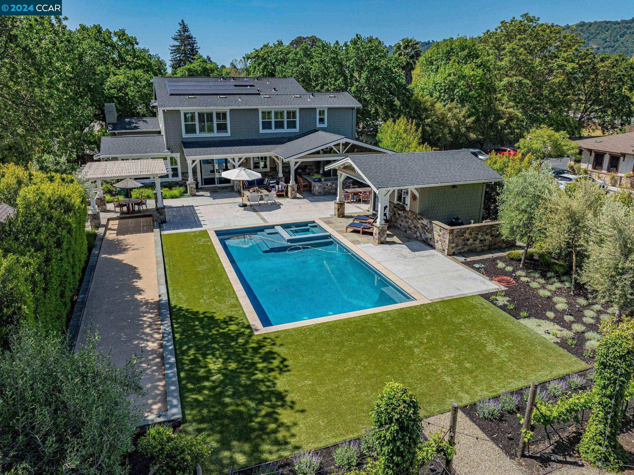 an aerial view of a house with swimming pool garden and patio