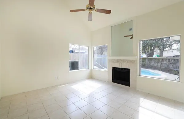 a view of a livingroom with a fireplace and window
