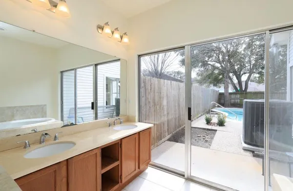 a spacious bathroom with a double vanity sink and a large mirror