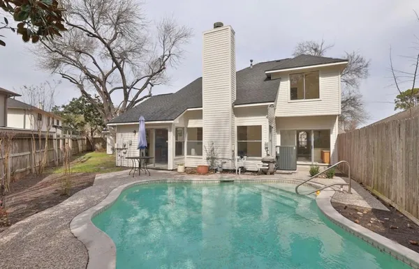 a view of a house with backyard porch and sitting area