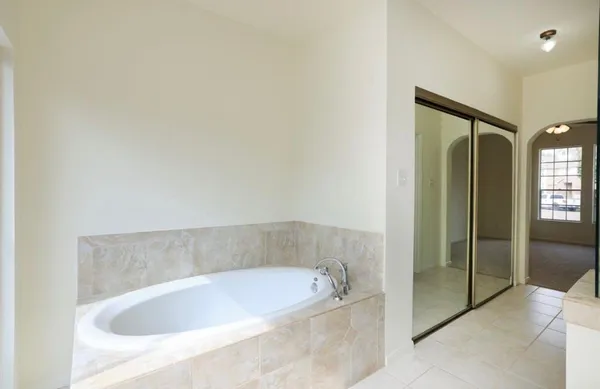 a bathroom with a bathtub and shower