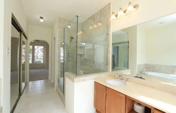a bathroom with a double vanity sink mirror and shower
