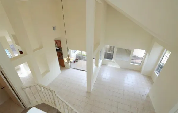 a view of a hallway with furniture and wooden floor