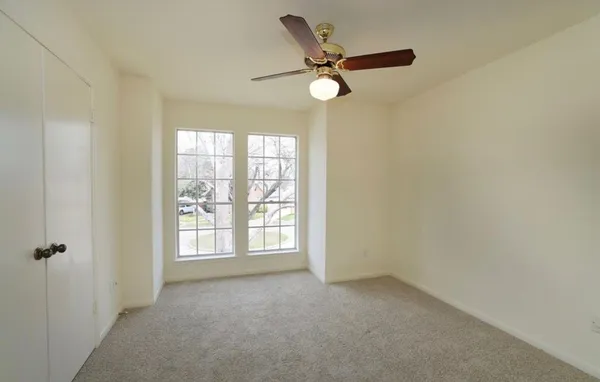 a view of a livingroom with a ceiling fan and window