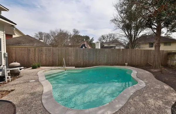 a view of a backyard with large trees