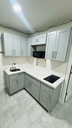 a kitchen with a cabinets and white appliances