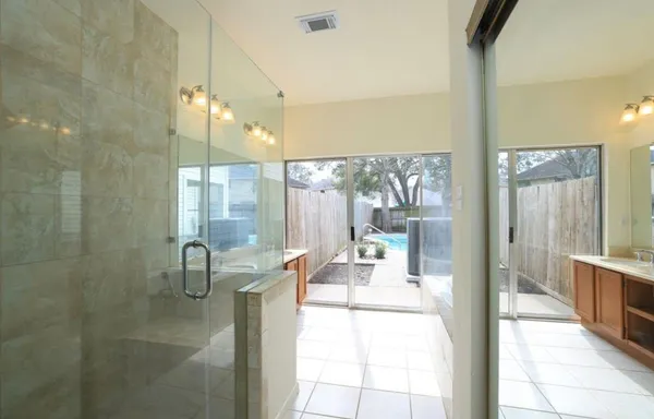 a lobby with a glass door and chandelier