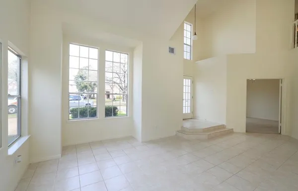 an empty room with windows and entrance