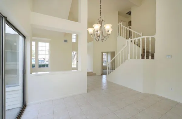a view of a livingroom with wooden floor and chandelier