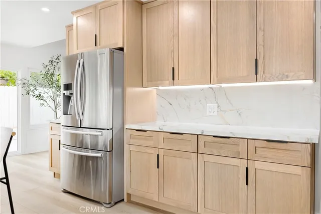 a kitchen with cabinets and stainless steel appliances