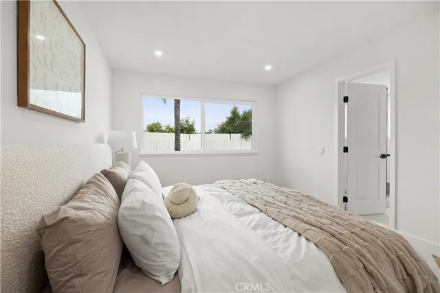 a bedroom with a bed and a painting on the wall