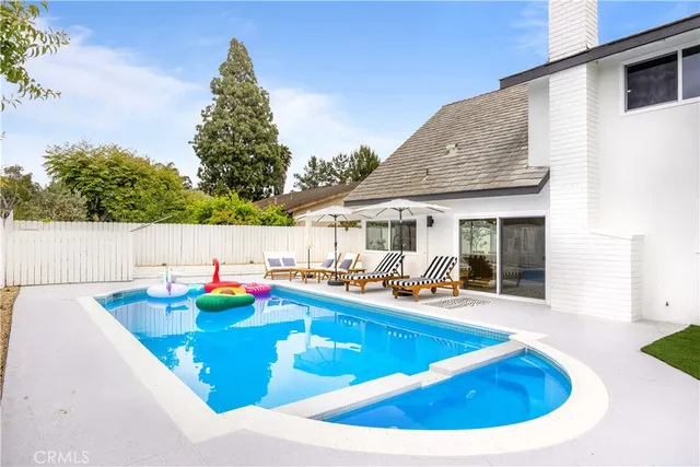 a view of swimming pool with outdoor seating