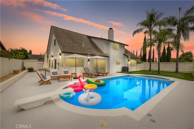 a view of a swimming pool with a lounge chairs in patio