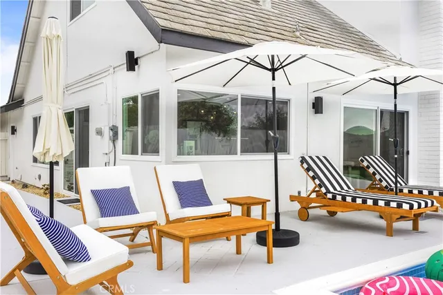 a balcony with couple of chairs and couch