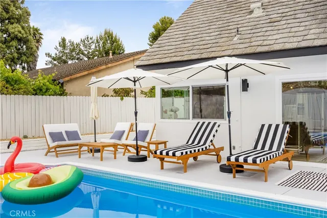 a backyard of a house with outdoor seating