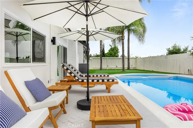 a view of a swimming pool with a lounge chair