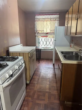 a kitchen that has a sink and a stove