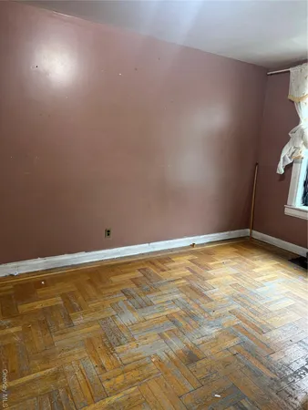 a view of a room with an empty space and window