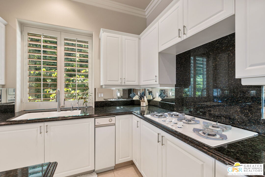 51 Killian Way Rancho Mirage, CA 92270 - Photo 28 of 71 a kitchen with granite countertop a sink a stove and cabinets