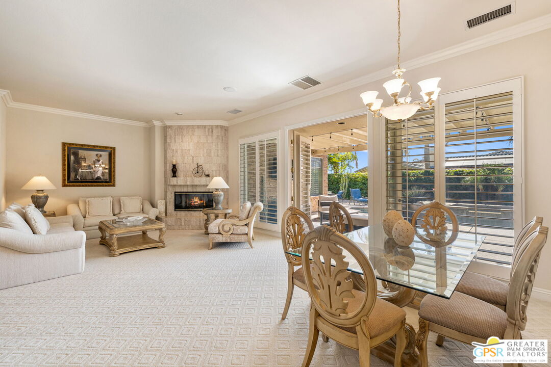 51 Killian Way Rancho Mirage, CA 92270 - Photo 37 of 71 a living room with furniture chandelier and a large window