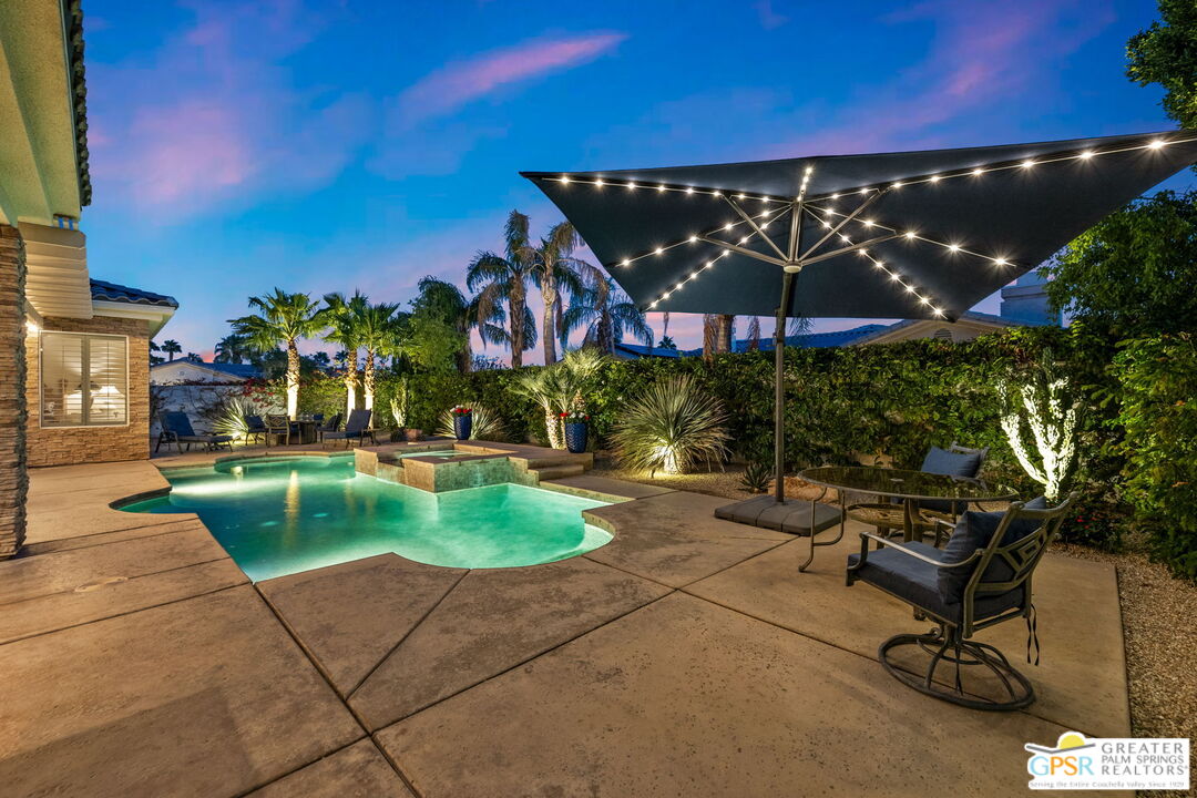 51 Killian Way Rancho Mirage, CA 92270 - Photo 4 of 71 a view of a patio with a table and chairs under an umbrella