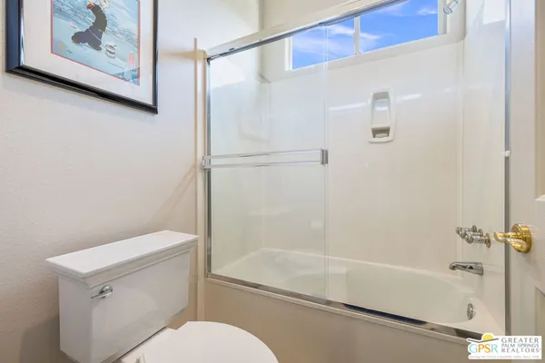 a view of a house with backyard sitting area and swimming pool