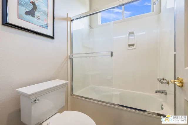 a view of a house with backyard sitting area and swimming pool