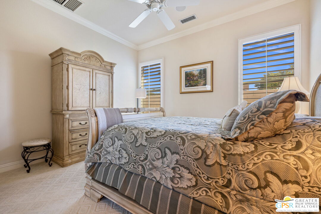 51 Killian Way Rancho Mirage, CA 92270 - Photo 48 of 71 a bedroom with a bed and a chandelier