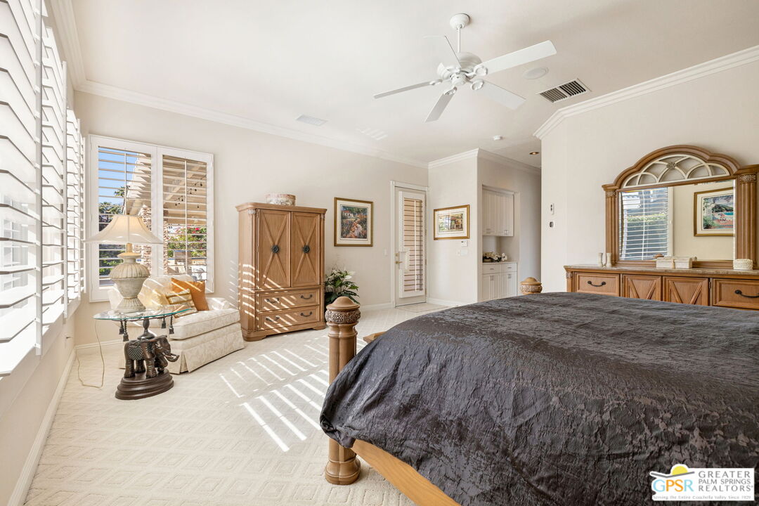 51 Killian Way Rancho Mirage, CA 92270 - Photo 54 of 71 a spacious bedroom with a bed a couch and dresser