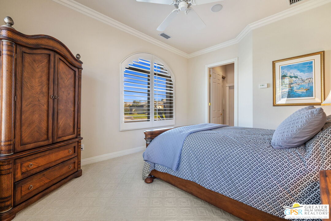 51 Killian Way Rancho Mirage, CA 92270 - Photo 58 of 71 a bedroom with a bed and cabinets