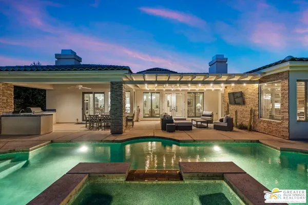 a outdoor living space with furniture and a flat screen tv