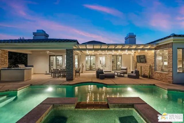 a outdoor living space with furniture and a flat screen tv