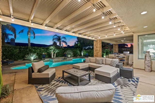 a view of a swimming pool with an outdoor seating