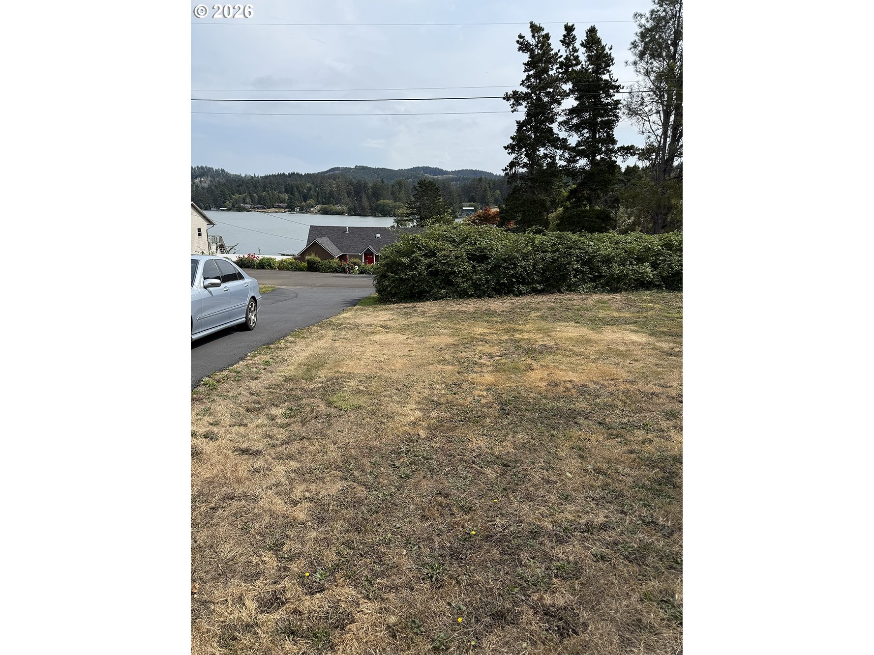 Northeast Johns Loop Neotsu, OR 97364 - Photo 3 of 4 a view of a outdoor space with trees in the background