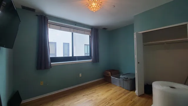 a room with wooden floor and a window