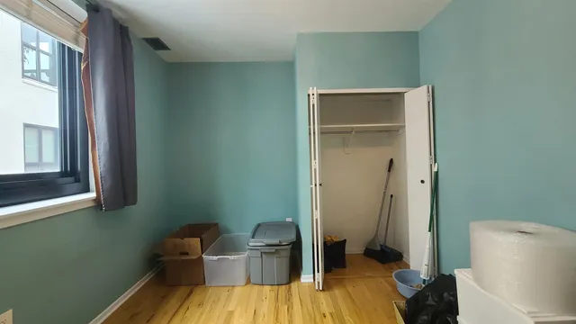 a view of a room that has a bed and a chair in it