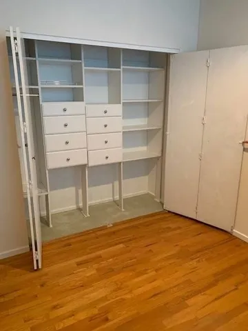 a view of an empty room with empty shelves