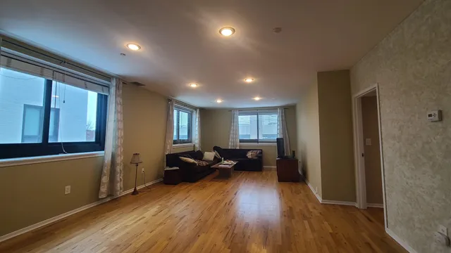 a view of a livingroom with furniture wooden floor and a window