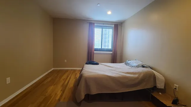 a bedroom with a bed and window