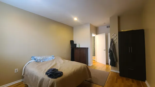 a bedroom with a bed and a dresser