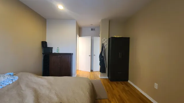 a bedroom with a bed and a mirror