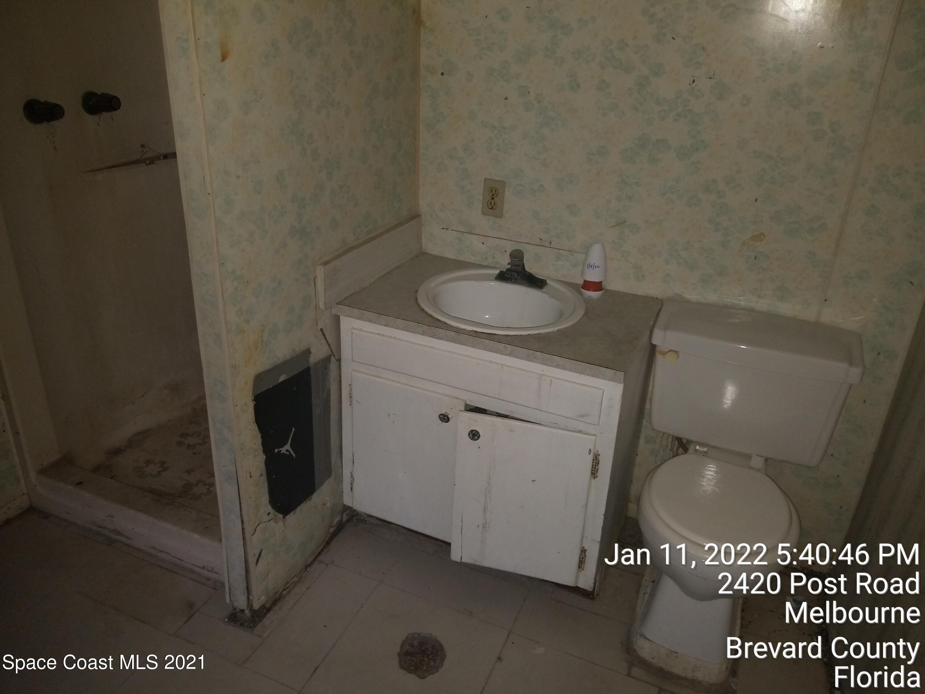 2420 Post Road Melbourne, FL 32935 - Photo 27 of 50 a bathroom with a sink and mirror