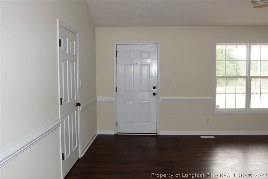 5836 Spreading Branch Road Hope Mills, NC 28348 - Photo 30 of 48 a view of an empty room with wooden floor and a window